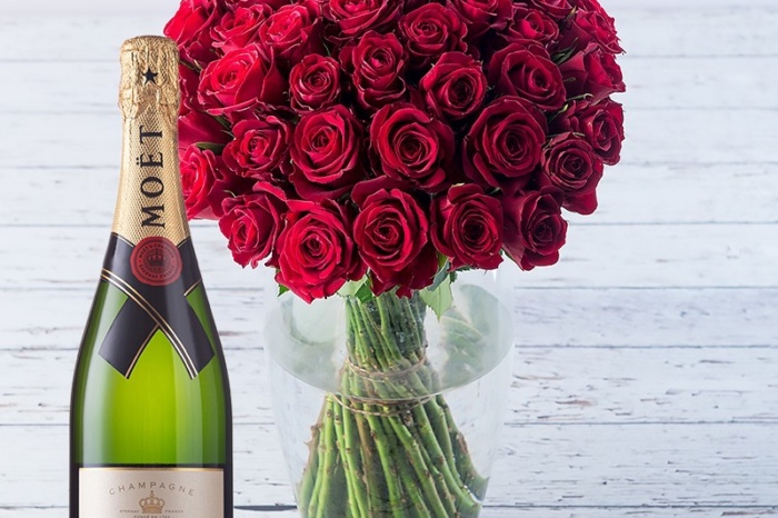 Red roses bouquet with champagne